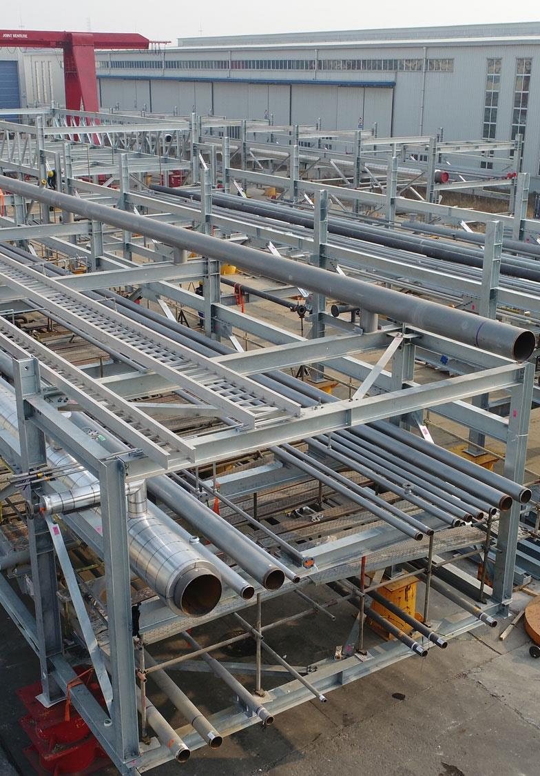 Galvanised pipe racks and spools laid out in the fabrication shop