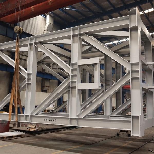 Structural steel frame fabricated for load out, the member weight stencilled on the web